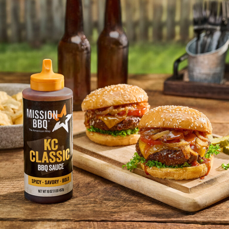 KC Classic BBQ Sauce outside on a table shown with two cheeseburgers