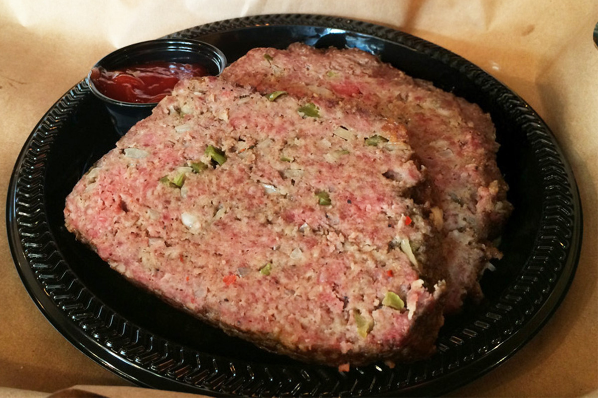 Picture of the MISSION BBQ Smoked Meatloaf Black Plate Special served with Chipotle Ketchup.